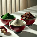Three red bowls with Spirulina, Lion’s Mane, and Reishi powders on a luxurious white table, showcasing premium superfoods.